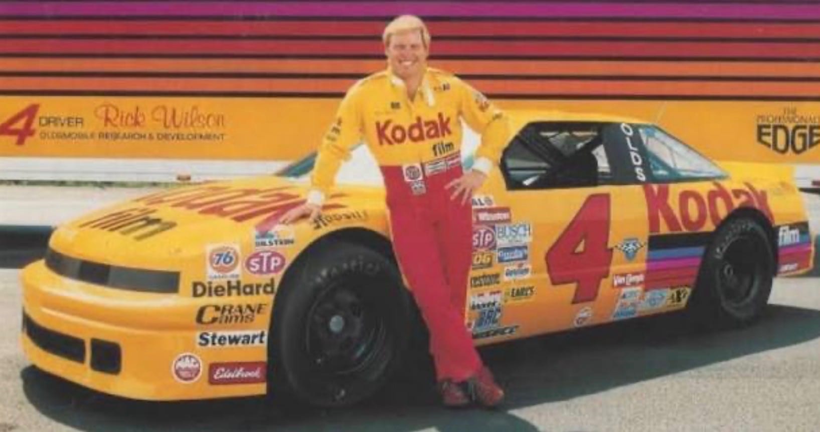 Rick Wilson beside his No. 4 car in front of the team hauler