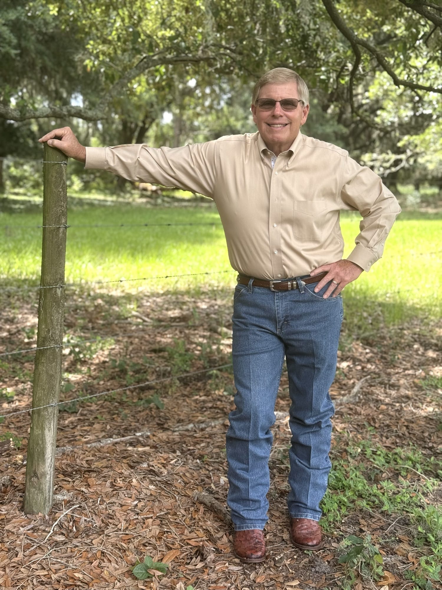 Rick Wilson at a fence line on the family ranch in Bartow